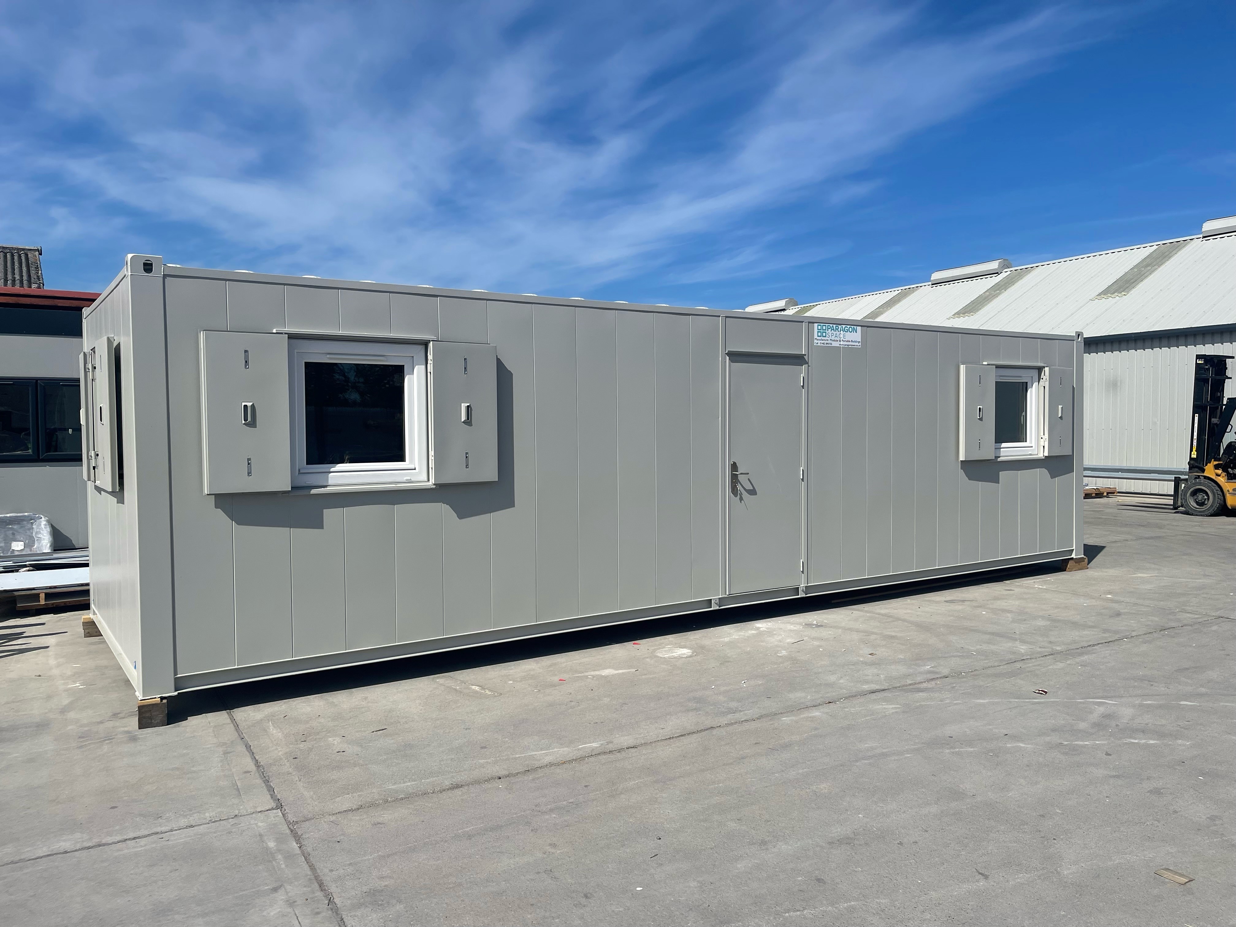Large modular office building with door in the centre and two windows at either side of the door.